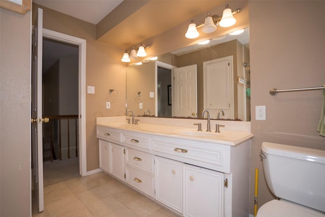 bathroom featuring tile patterned flooring, vanity, and toilet