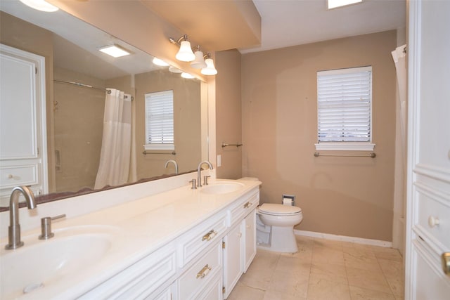 bathroom featuring vanity, curtained shower, and toilet