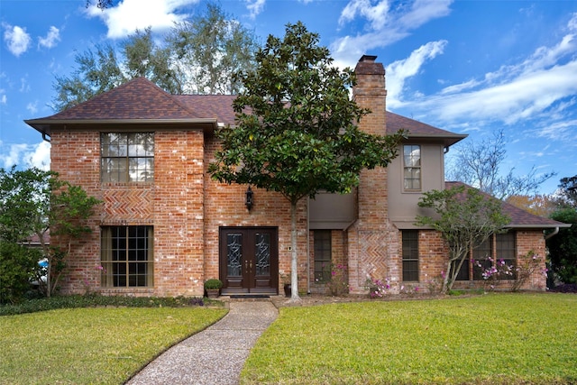 view of front of property featuring french doors and a front yard