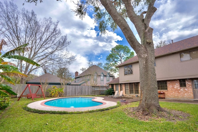 view of swimming pool with a playground, a yard, and a patio area