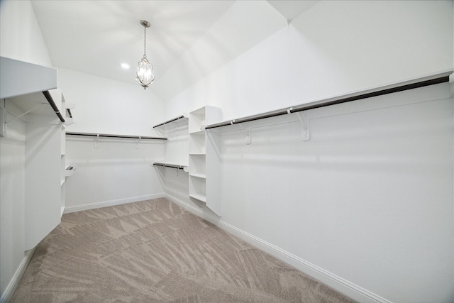 walk in closet featuring vaulted ceiling and light carpet