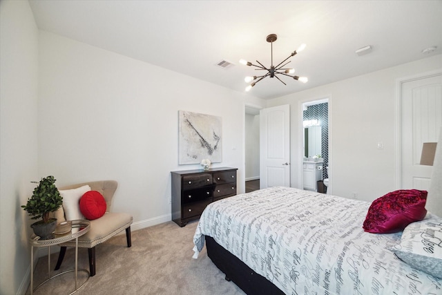 carpeted bedroom with an inviting chandelier and ensuite bathroom