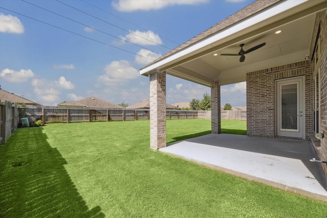 view of yard featuring ceiling fan and a patio