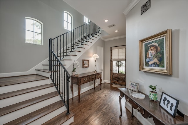 stairway featuring hardwood / wood-style floors and crown molding