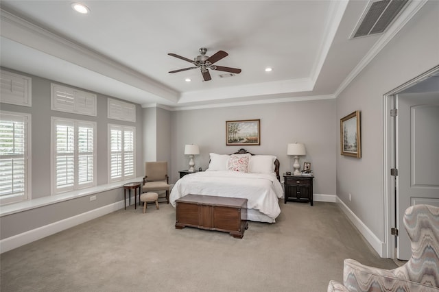 carpeted bedroom with crown molding, ceiling fan, and a tray ceiling