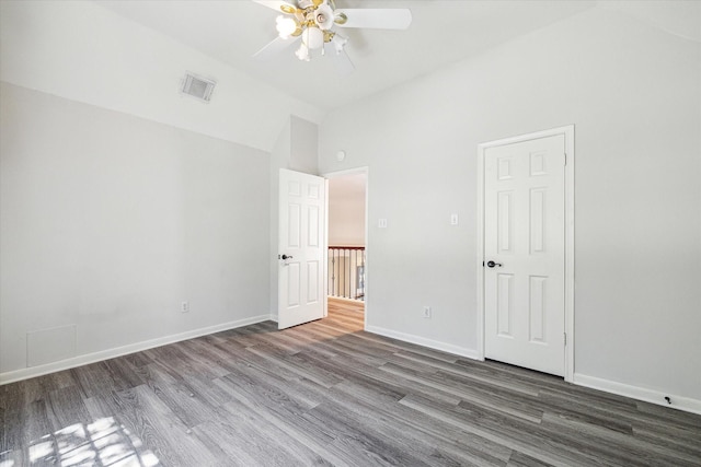 unfurnished bedroom with high vaulted ceiling, dark wood-type flooring, and ceiling fan