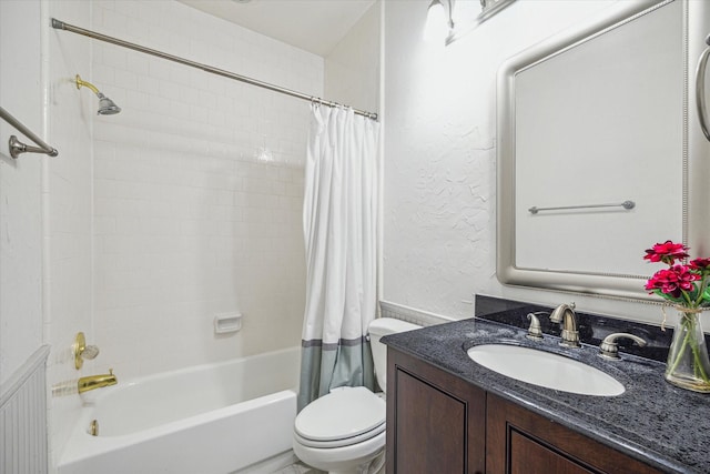 full bathroom featuring vanity, shower / tub combo, and toilet