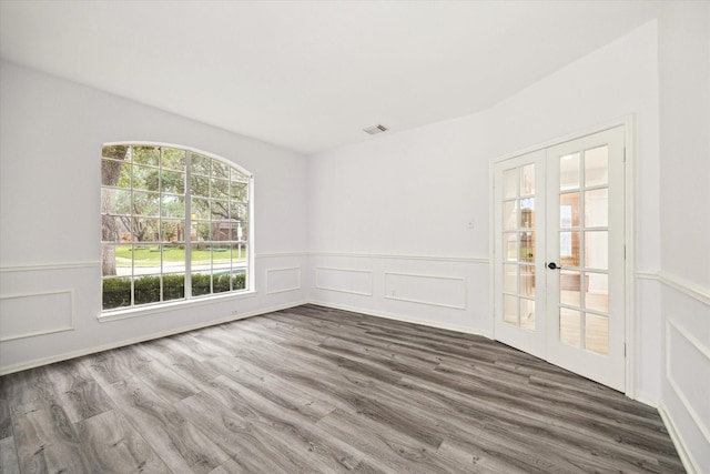 empty room featuring french doors and wood-type flooring