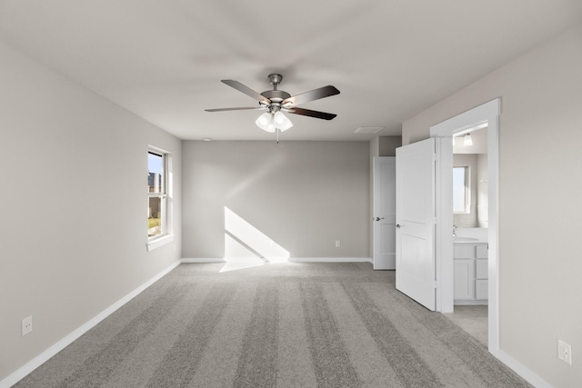 carpeted spare room with sink and ceiling fan