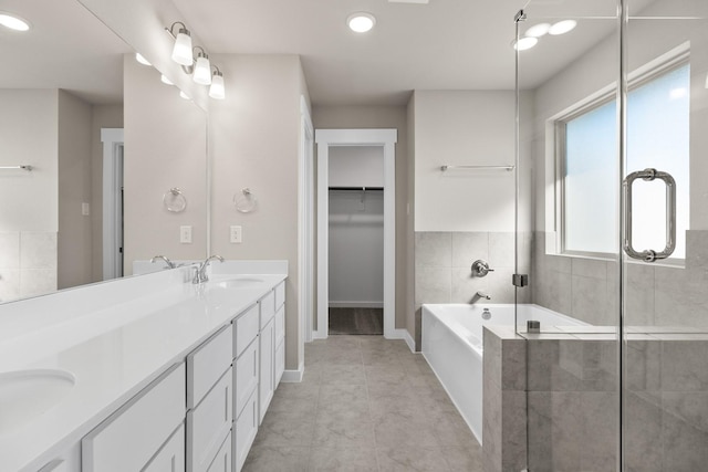 bathroom with tile patterned flooring, vanity, independent shower and bath, and a wealth of natural light