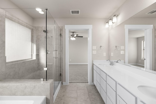 bathroom with tile patterned flooring, vanity, an enclosed shower, and ceiling fan