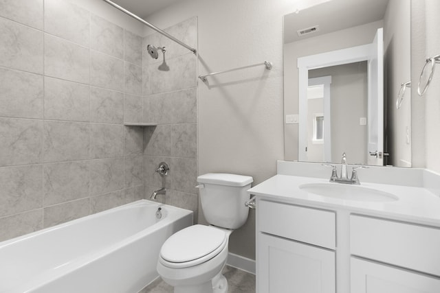 full bathroom with vanity, toilet, and tiled shower / bath