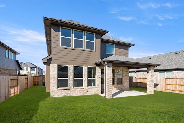 back of house featuring a yard and a patio