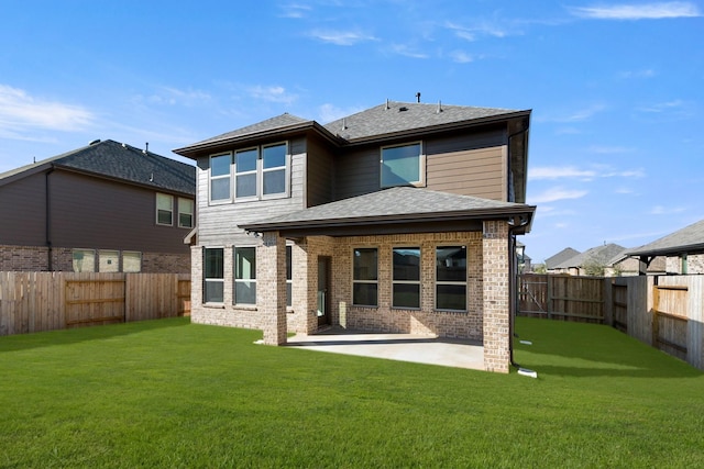 back of house with a yard and a patio