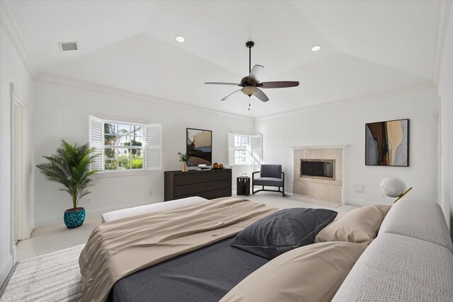 bedroom with ceiling fan, ornamental molding, a fireplace, and multiple windows