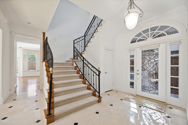 foyer featuring crown molding