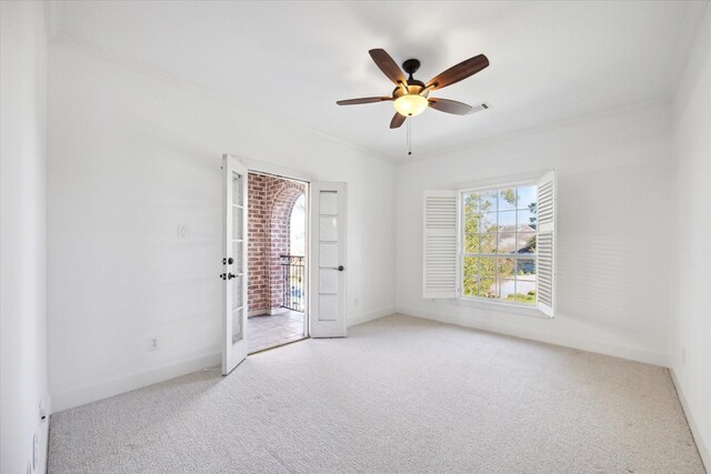 carpeted spare room with crown molding and ceiling fan