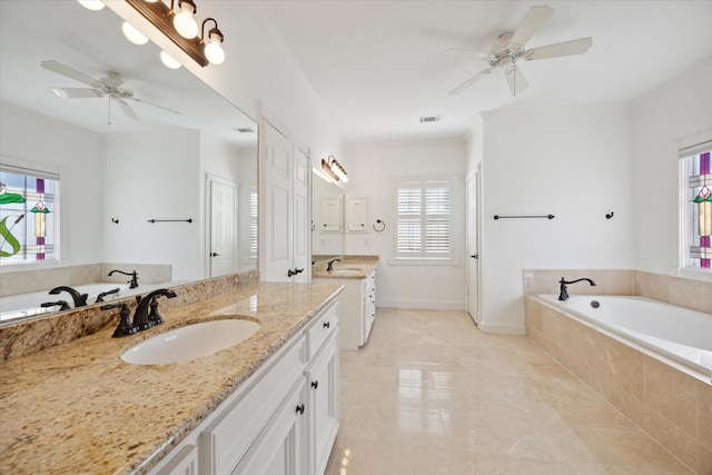 bathroom with vanity, tiled tub, and ceiling fan