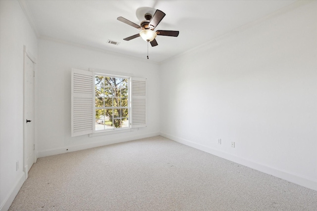 unfurnished room with ceiling fan, ornamental molding, and light carpet