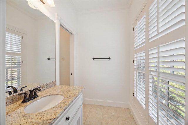 bathroom with crown molding, tile patterned floors, plenty of natural light, and vanity