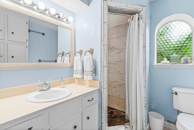 bathroom featuring vanity, a wealth of natural light, toilet, and walk in shower