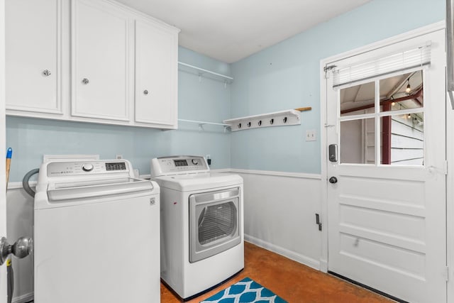 washroom featuring washer and dryer and cabinets