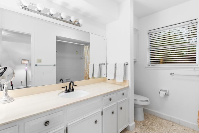 bathroom with vanity, curtained shower, and toilet