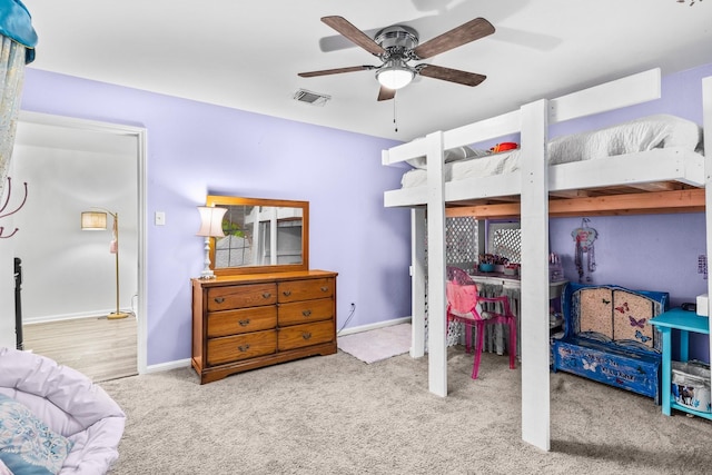 bedroom featuring light colored carpet, a closet, and ceiling fan