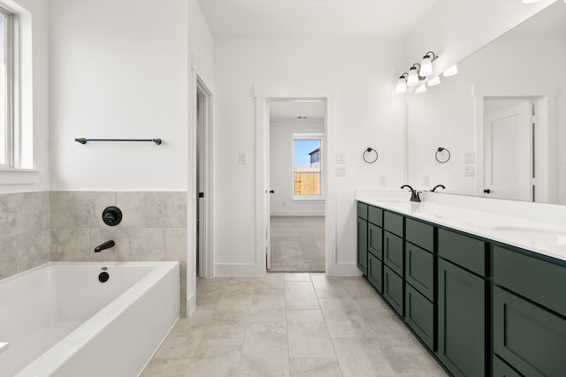 bathroom featuring vanity, a bathing tub, and tile patterned floors