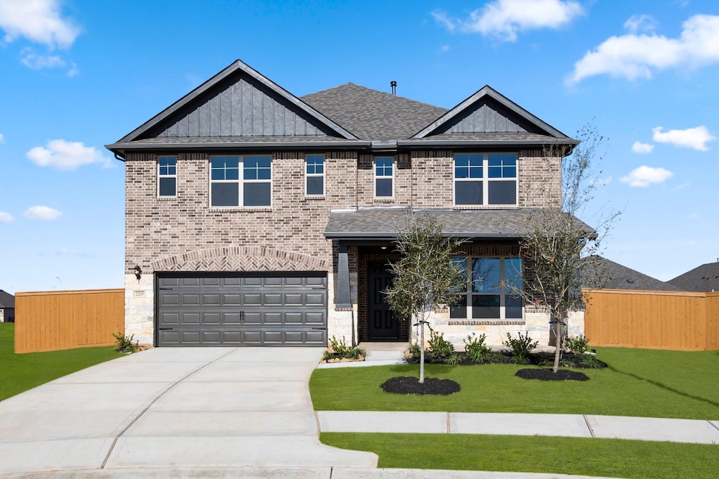 view of front of property featuring a garage and a front yard