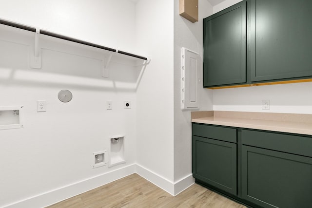 washroom with cabinets, light wood-type flooring, electric dryer hookup, washer hookup, and hookup for a gas dryer