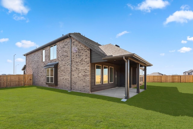 back of property featuring a patio area and a lawn