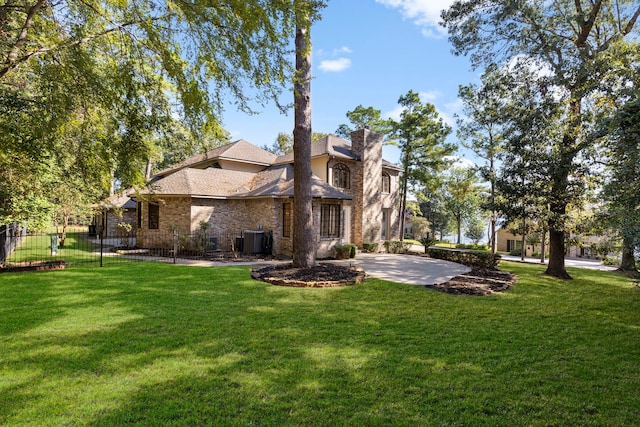 back of property with cooling unit, a patio area, and a lawn