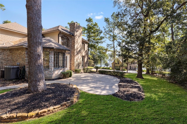 view of yard with central AC unit and a patio