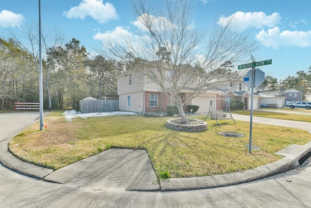 view of front of property with a garage and a front yard