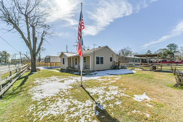 back of house with a lawn