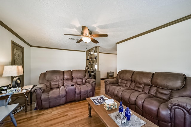5411 Pecan St, Crosby, TX 77532 - living room with ornamental molding, ceiling fan, a textured ceiling, and light hardwood / wood-style flooring