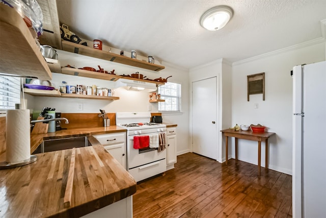 5411 Pecan St, Crosby, TX 77532 - kitchen with dark hardwood / wood-style floors, sink, white cabinets, wooden counters, and white appliances