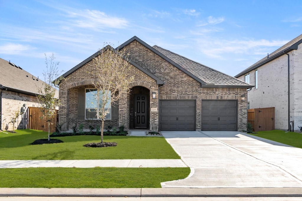 view of front of home with a garage and a front yard