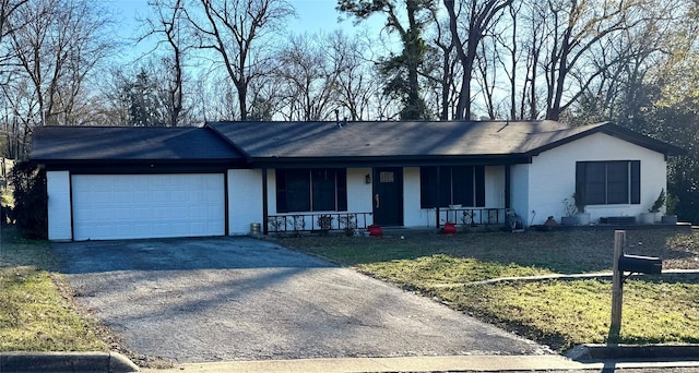 ranch-style home with a garage and a front yard