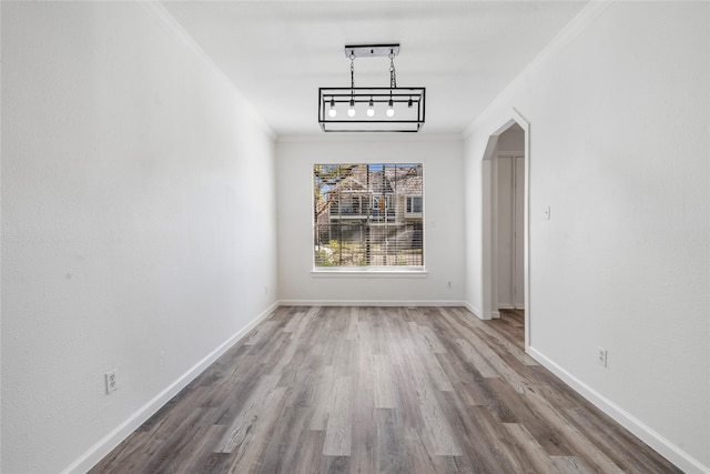 unfurnished dining area with ornamental molding and hardwood / wood-style floors