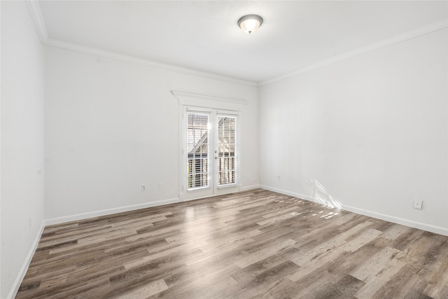 unfurnished room featuring ornamental molding and wood-type flooring