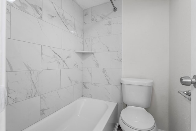 bathroom featuring tiled shower / bath and toilet