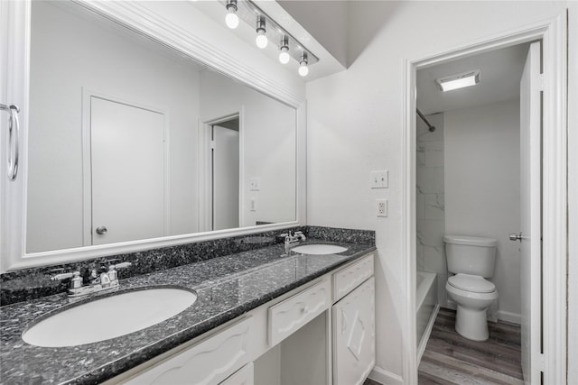 bathroom featuring vanity, wood-type flooring, and toilet