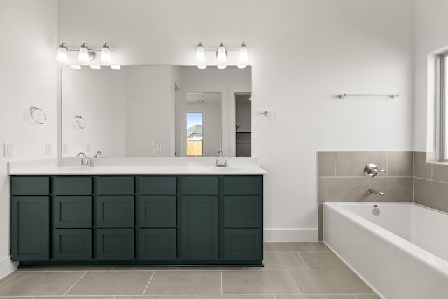 bathroom featuring tile patterned flooring, vanity, a bathtub, and plenty of natural light