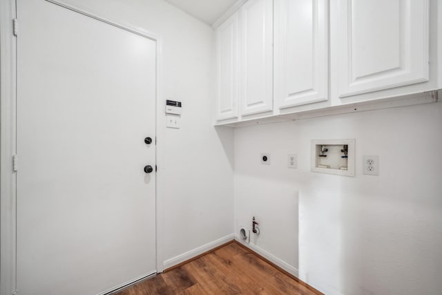 laundry area with gas dryer hookup, dark hardwood / wood-style floors, cabinets, hookup for a washing machine, and hookup for an electric dryer