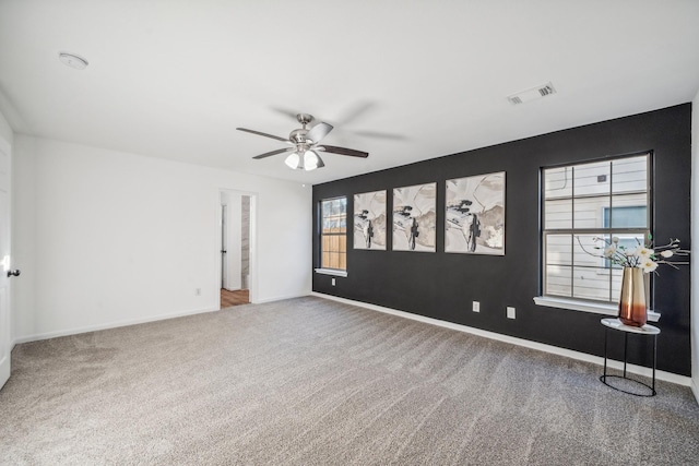 carpeted empty room featuring ceiling fan