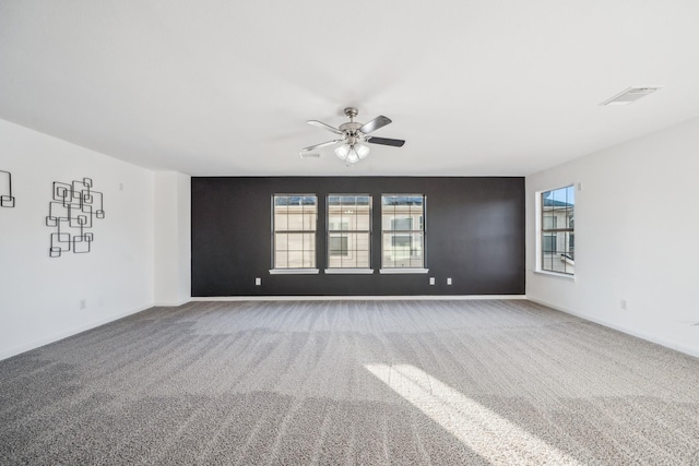 spare room featuring ceiling fan and carpet flooring