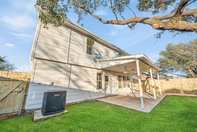 rear view of house with ceiling fan, a patio area, a lawn, and central air condition unit