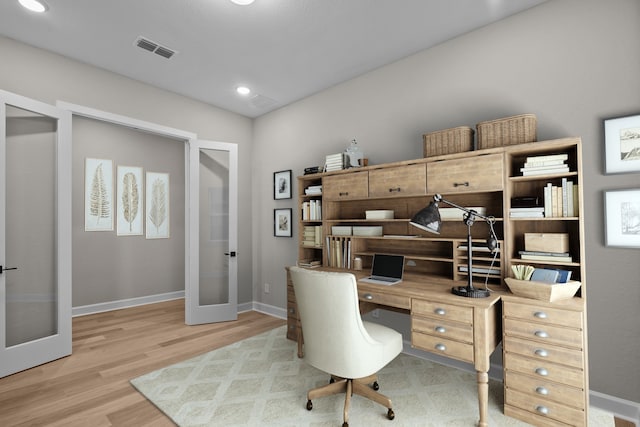 office space with light wood-type flooring and french doors